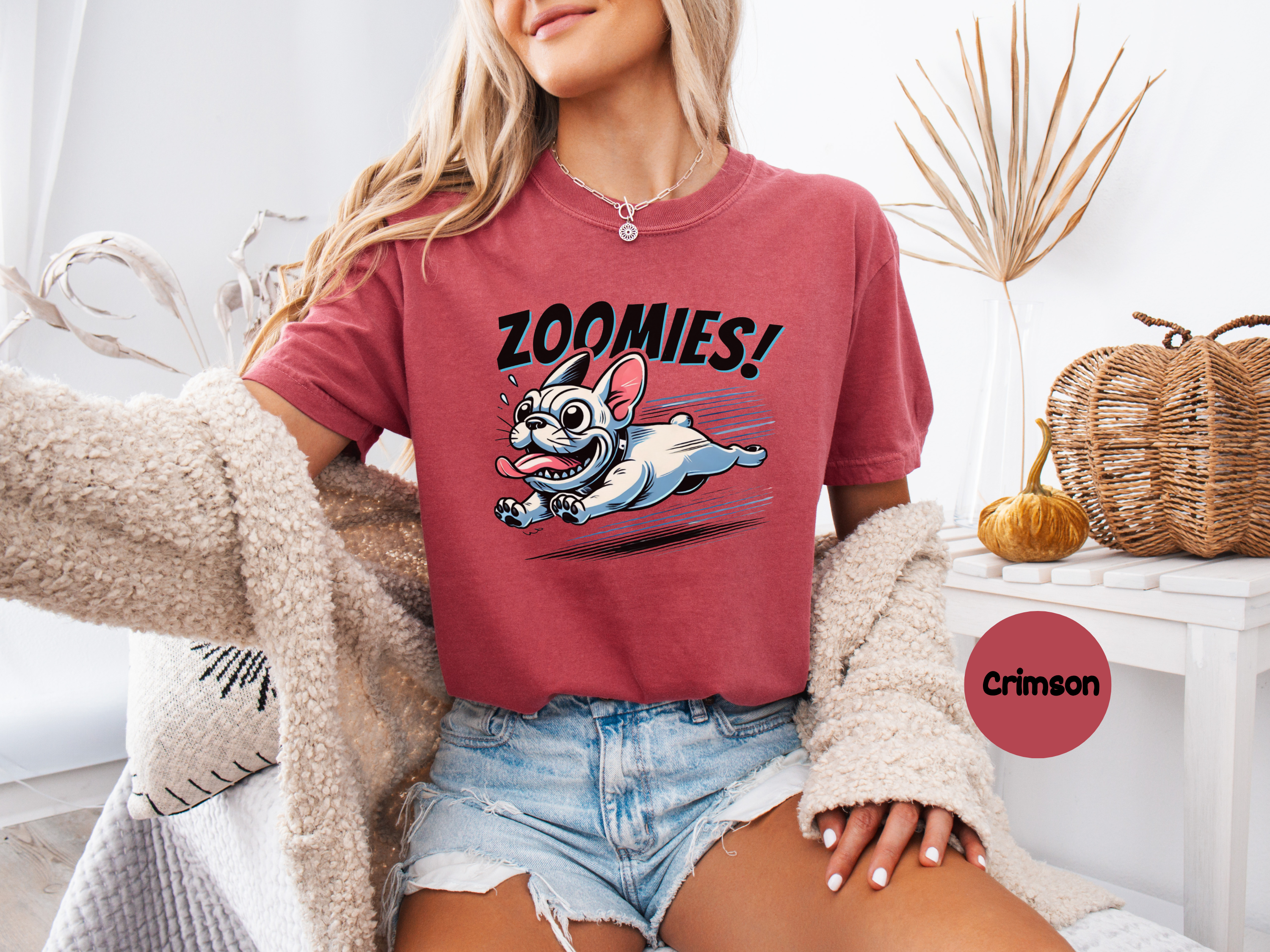 red t-shirt with a french bulldog and 'Zoomies!' text, sitting indoors.