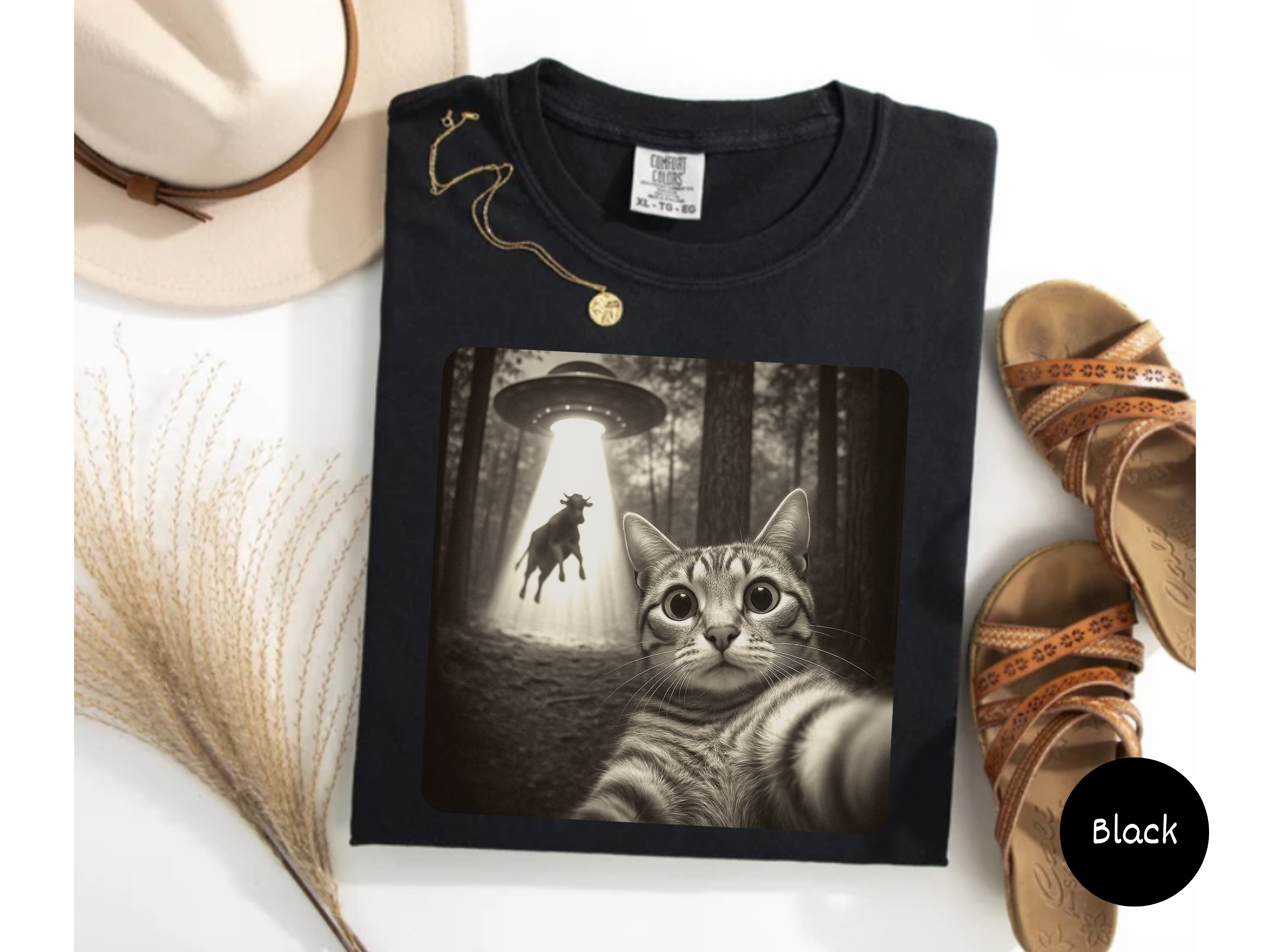 Alien spaceship cat tee showing cat being lifted in beam while snapping selfie ideal for meme apparel and gifts.