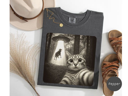 Alien cat t-shirt featuring selfie moment beneath flying saucer graphic ideal for cat mom dad or gift idea.