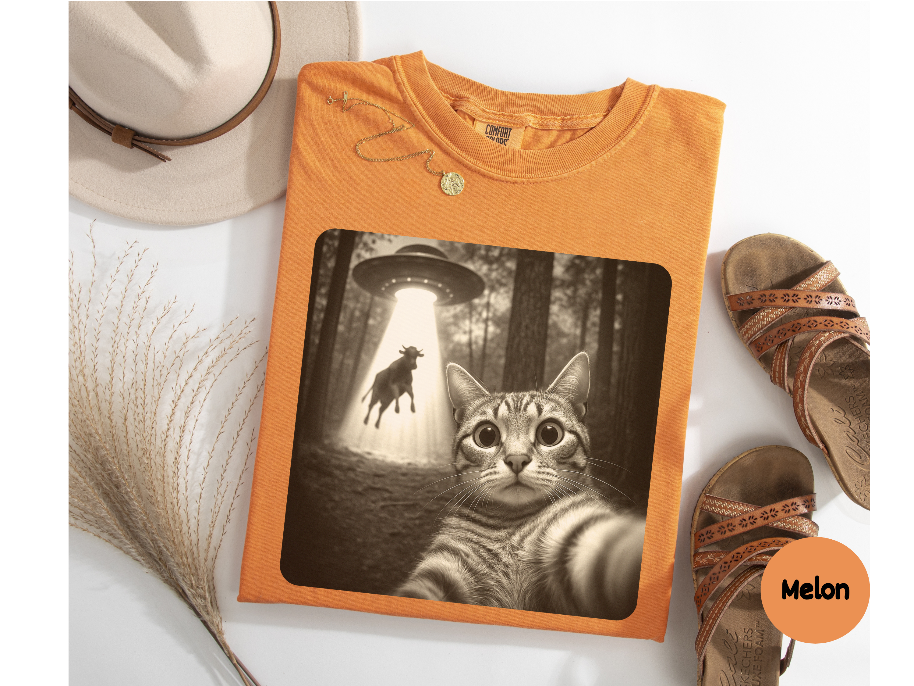 Funny UFO cat graphic tee featuring a curious feline mid-abduction on soft unisex shirt ideal for meme gift.