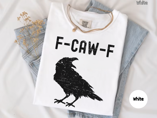 White t-shirt with black crow graphic and 'F-CAW-F' text on a light gray background