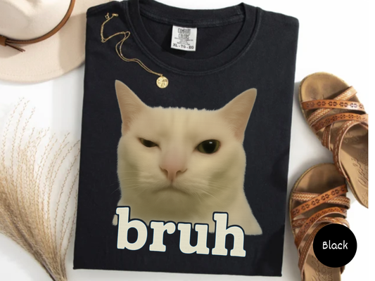 Deadpan white cat face with unimpressed expression and bruh text creating a sarcastic viral meme design on black background