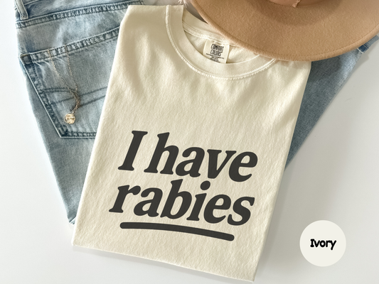 I have rabies graphic tee featuring simple white text on a black shirt designed for people who enjoy weird humor and unexpected sarcastic statements