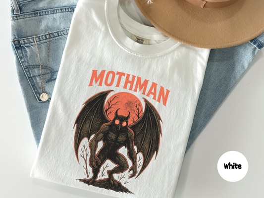 Urban legend inspired Mothman t shirt showing a winged monster in dramatic lighting with vintage texture popular with paranormal enthusiasts cryptid collectors and horror art lovers