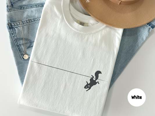 Funny squirrel t shirt featuring a minimalist black silhouette of a squirrel slipping and falling off a thin line on a white background