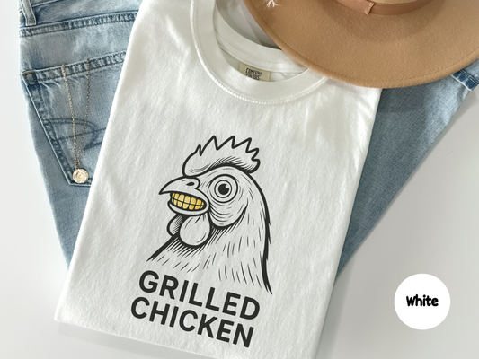 Funny grilled chicken t shirt featuring creepy chicken illustration with glowing yellow teeth and dark humor text