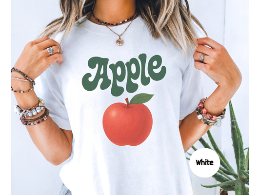 Apple fruit graphic t shirt featuring a bright red apple illustration with green leaf and retro apple lettering on black background