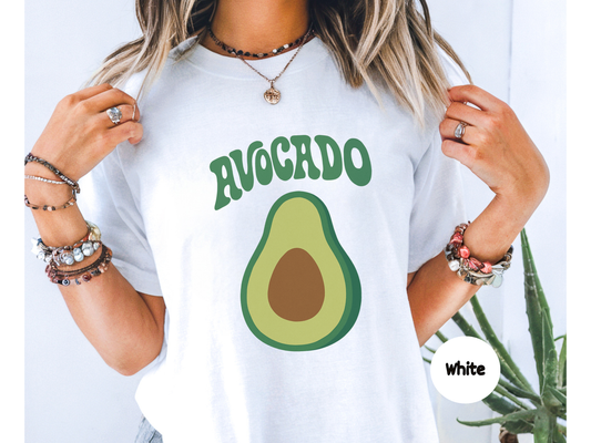 Avocado fruit graphic t shirt featuring a minimalist green avocado with brown pit and retro curved avocado text on black background